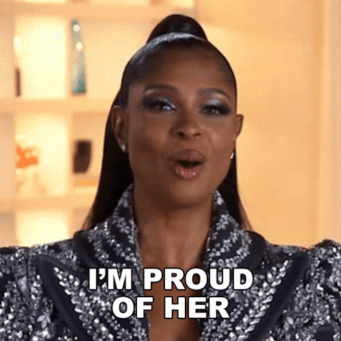 a woman wearing a sequined jacket is saying i 'm proud of her