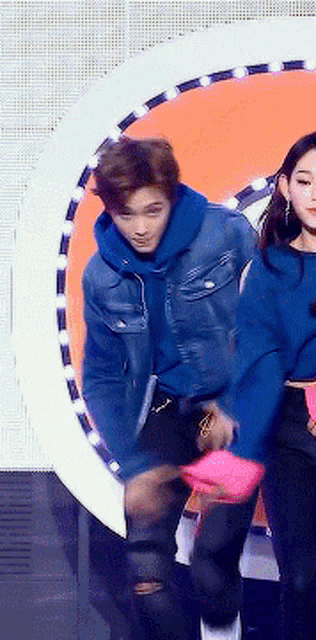 a man and a woman are standing next to each other on a stage