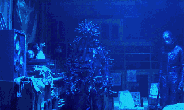 a dark room with a blue light shining on a person