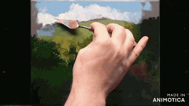 a hand is holding a spatula and painting on a canvas with the words made in animotica below it