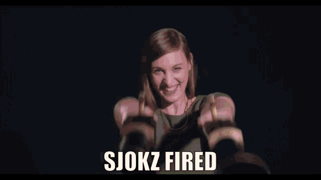 a woman is smiling while holding a gun with the words sjokz fired below her