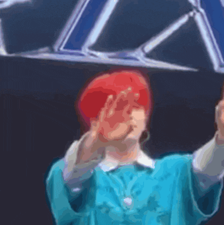 a woman with red hair is covering her face with her hand