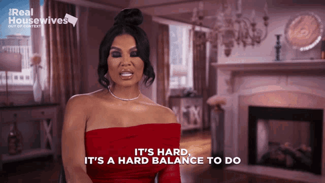 a woman in a red dress says it 's hard and it 's a hard balance to do