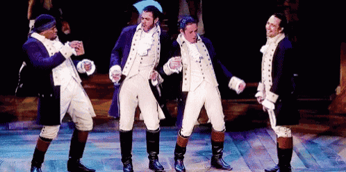 a group of men are dancing on a stage in historical costumes .