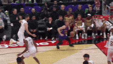 a basketball player wearing a white jersey with the number 3 on it is jumping in the air