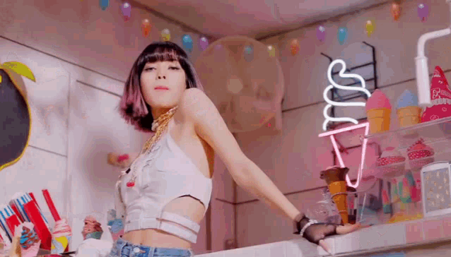 a woman is standing in front of an ice cream cone in a room .