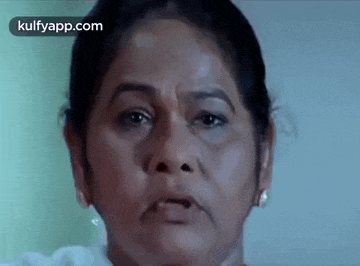 a close up of an older woman 's face with a serious look on her face .