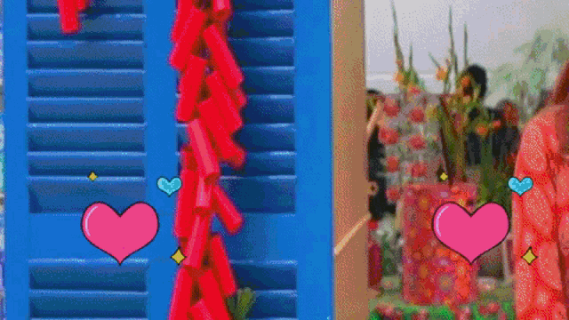 a woman in a red dress is standing in front of a window with shutters and fireworks hanging from it .