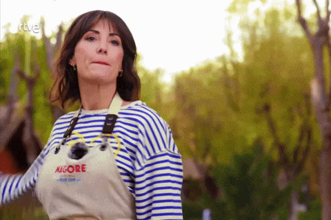a woman wearing a striped shirt and an apron that says algore