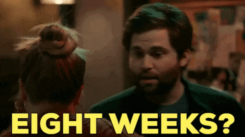 a man and a woman are looking at each other and the man is saying eight weeks ?