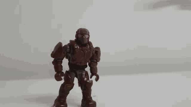 a toy figure with a helmet on stands on a table