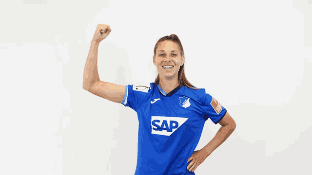 a woman wearing a blue shirt with the word sap on the front
