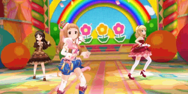 three anime girls are dancing on a stage in front of a colorful rainbow .