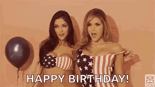 two women in bikinis are standing next to each other and one of them is taking off her shirt .