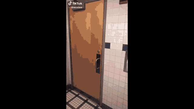 a group of young men are dancing in a hallway in front of a toilet .
