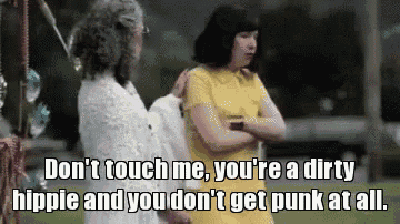 a woman in a yellow dress is talking to another woman in a white dress