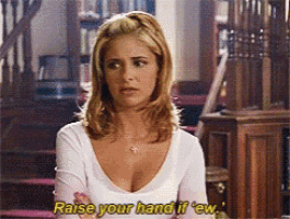 a woman in a white shirt says " raise your hand if ' ew "
