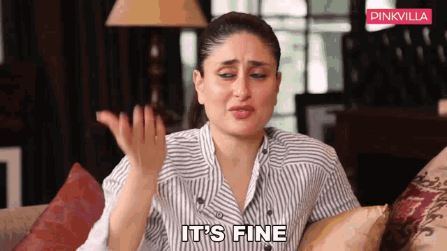 a woman in a striped shirt says it 's fine while sitting on a couch
