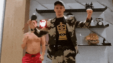 a man in a camouflage suit has a shirt on that says ' king '