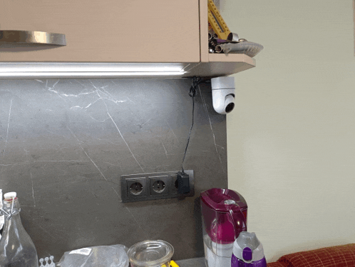 a kitchen counter with a pitcher and a blender