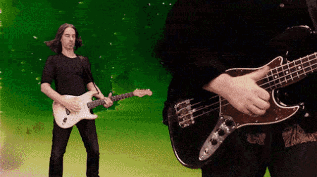 a man playing a bass guitar next to another man playing an electric guitar