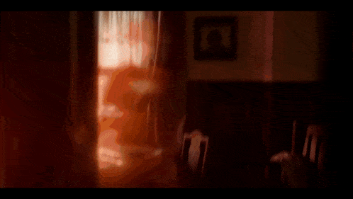 a blurry picture of a window with the sun shining through