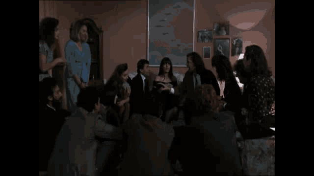 a man in a suit and shirt is standing in a hallway with a group of people .