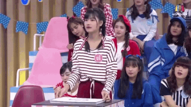 a group of young girls are sitting in a stadium .