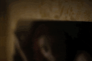 a close up of a person 's hand holding a cell phone in the dark .