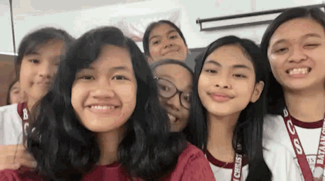 a group of young girls are posing for a picture together .