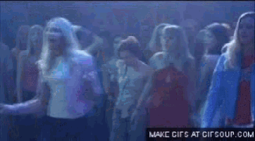 a woman in a pink jacket is dancing in front of a crowd and says i know you hookers