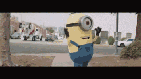 a yellow minion with a big eye is walking down a sidewalk
