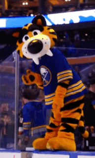 a mascot wearing a sabres jersey stands on a rink