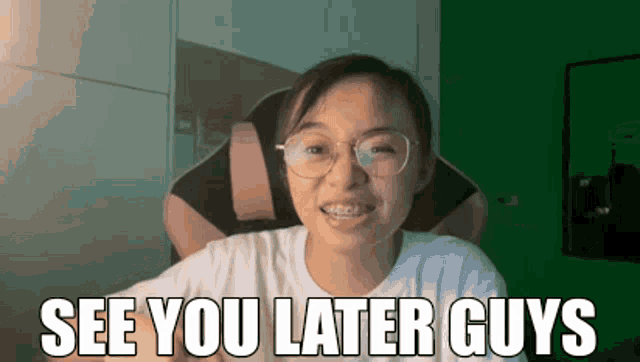 a woman wearing glasses is sitting in a chair and says " see you later guys "