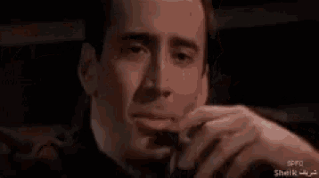 a close up of a man smoking a cigarette in a car .