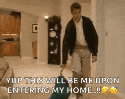 a man is carrying a suitcase in a living room and says yup this will be me upon entering my home ...