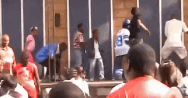 a man wearing a jersey with the number 35 on it is dancing in front of a crowd of people
