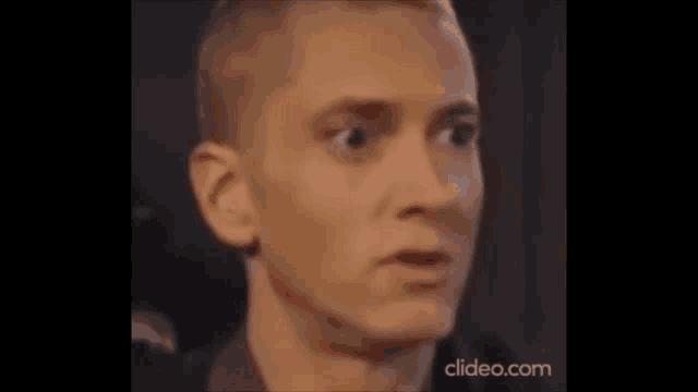 a close up of a man 's face with his mouth open and a surprised look on his face .
