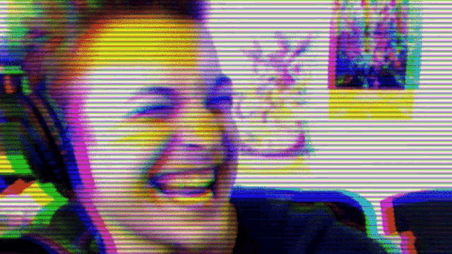 a man wearing headphones is making a funny face in a blurry photo .