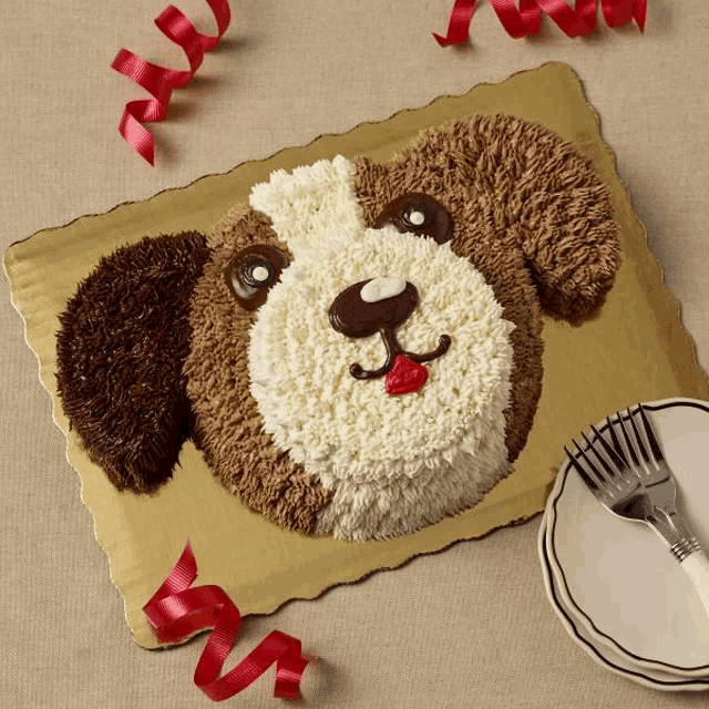 a cake in the shape of a dog 's head with a fork