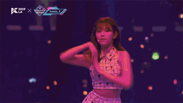 a woman is dancing on a stage in front of a screen that says ' count down ' on it