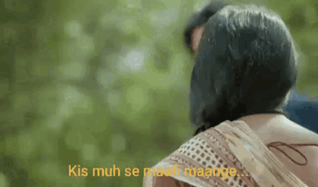a man and a woman are standing next to each other in a park .