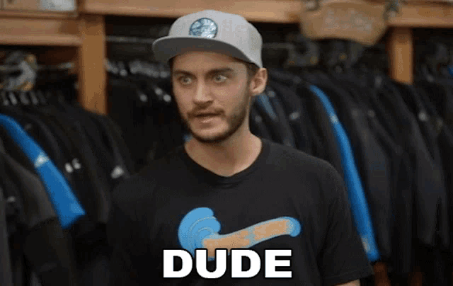 a man wearing a hat and a shirt that says dude on it