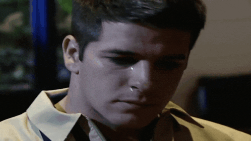 a man with a tear running down his face