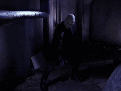 a blurry picture of a man in a mask in a dark room