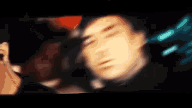 a blurry picture of a man 's face with a woman behind him
