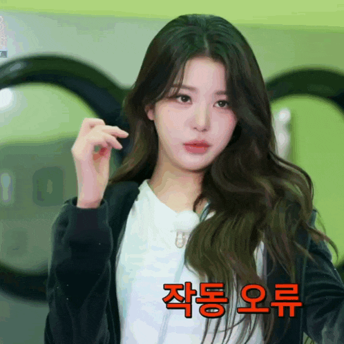 a girl with long hair is wearing a black jacket and white shirt