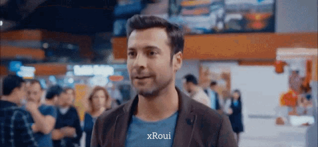 a man in a blue shirt that says xroui
