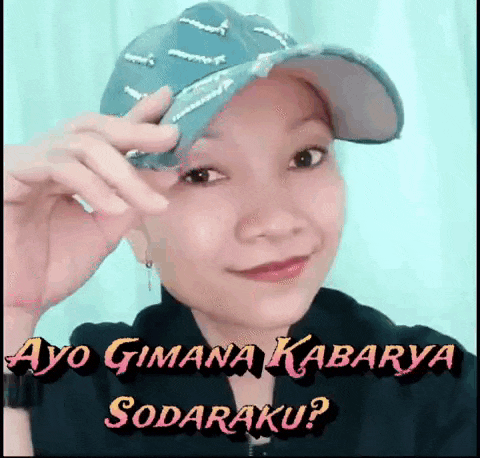 a woman wearing a baseball cap with the words ayo gimana kabarya sodaraku written on it