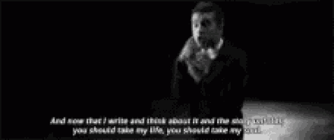 a man in a suit is talking on a cell phone .